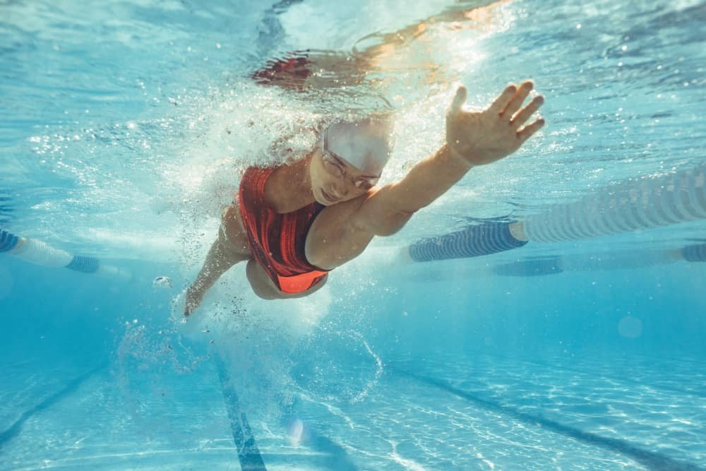 Underwater shot of female athlete swimming in pool